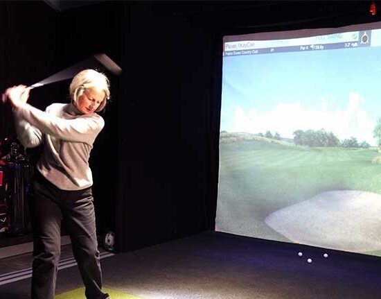 Woman playing simulated golf