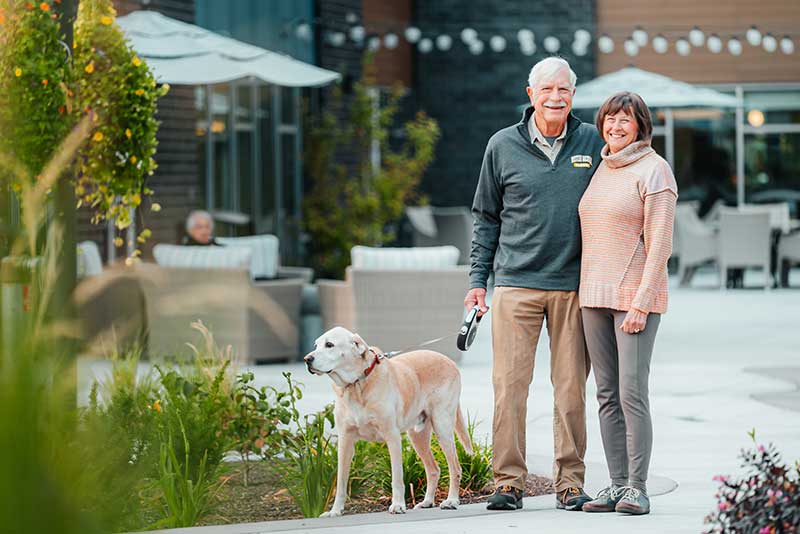 Couple walking their dog