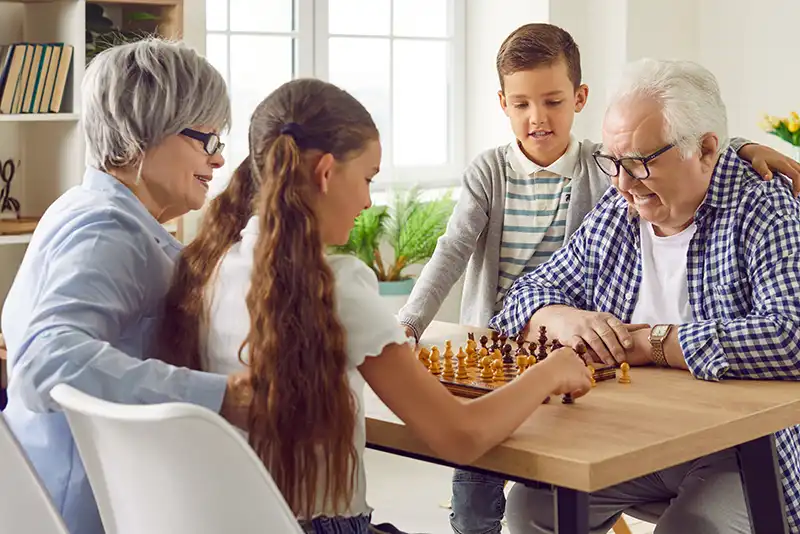 Family playing chess together